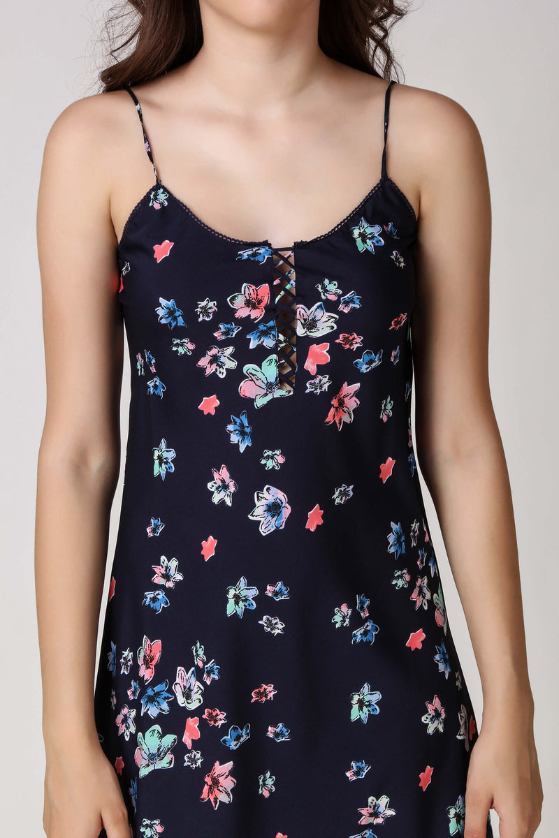 Floral navy dress with spaghetti straps and lace-up detail.