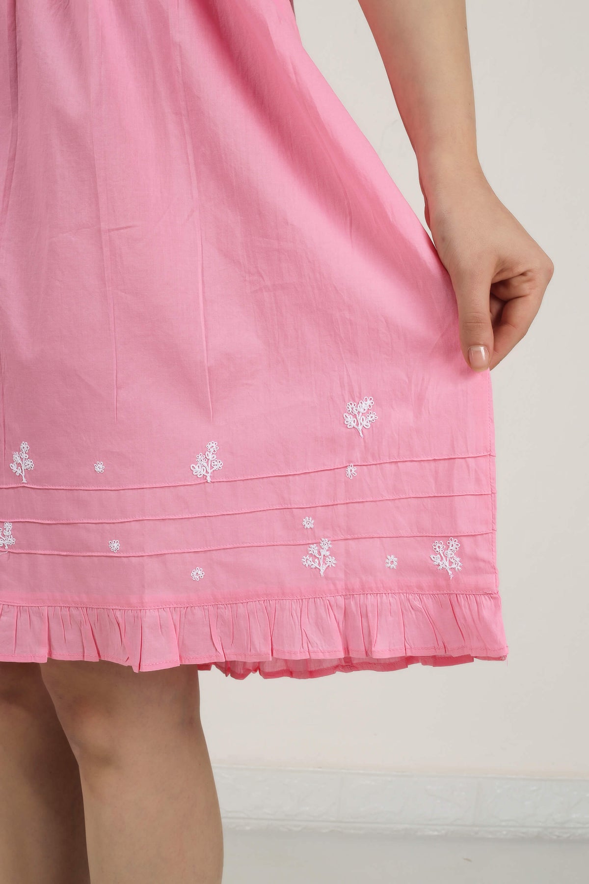 Pink nightdress with floral embroidery and frill hem detailing.