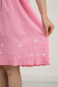 Pink nightdress with floral embroidery and frill hem detailing.