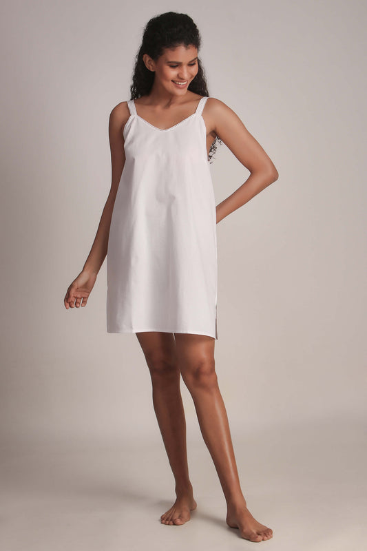 Short white slip dress with adjustable straps for women.