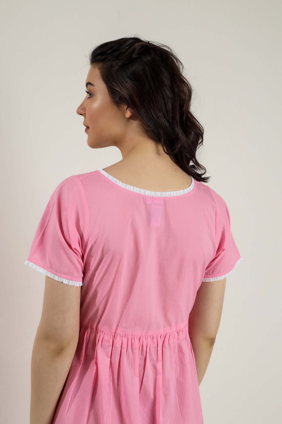 Sally Nightdress in pink, featuring delicate ruffled trim details.