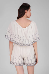 Back view of white Joyce romper with floral embroidery.