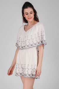 Joyce romper with floral embroidery and relaxed fit.